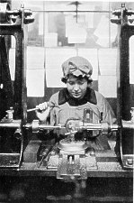 Woman operating drilling machine on part of a fuse