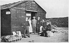 Friends' Emergency Hut Outside Internment Camp, Knockaloe, Isle-Of-Man, Showing some of the Committee's Staff, and Miss Soneson and Herr Voss and Herr Krohn (Weaving Pupils) seated